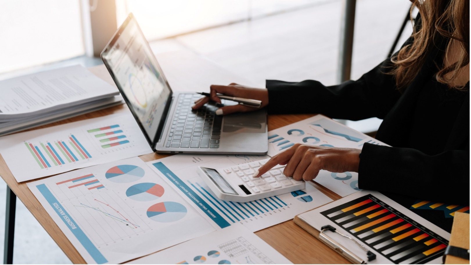 Benefits of outsourcing bookkeeping - Bookkeeper working on documents